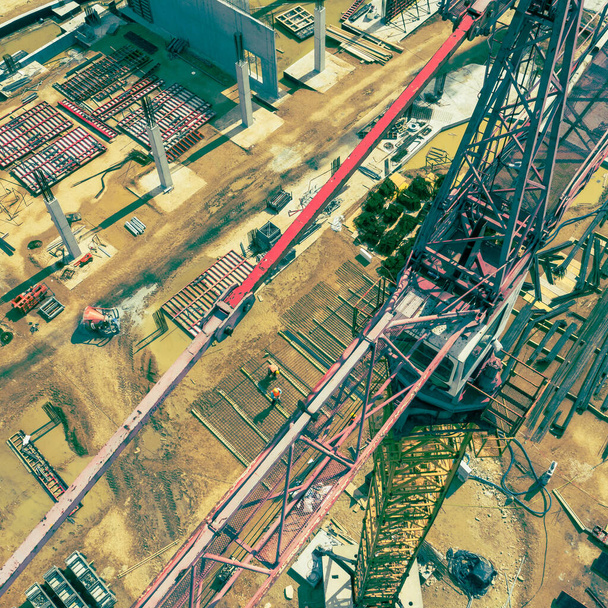 Construction site from above. Aerial view of workplaces in construction equipment, workers with heavy machinery. Industrial top view made by drone.  - Photo, Image