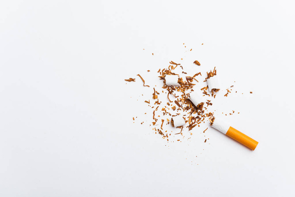 31 May of World No Tobacco Day, no smoking, close up of broken pile cigarette or tobacco STOP symbolic on white background with copy space, and Warning lung health concept - 写真・画像