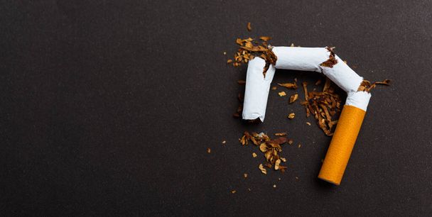 31 May of World No Tobacco Day, no smoking, close up of broken pile cigarette or tobacco STOP symbolic on black background with banner copy space, and Warning lung health concept - Φωτογραφία, εικόνα