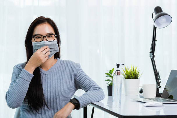 Asian young business beautiful woman during wearing face mask protective working from home office with laptop computer desk he quarantines disease coronavirus or COVID-19 virus - Foto, Bild