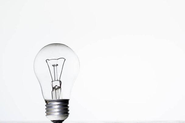 Light bulb frying on a white background isolate - Zdjęcie, obraz