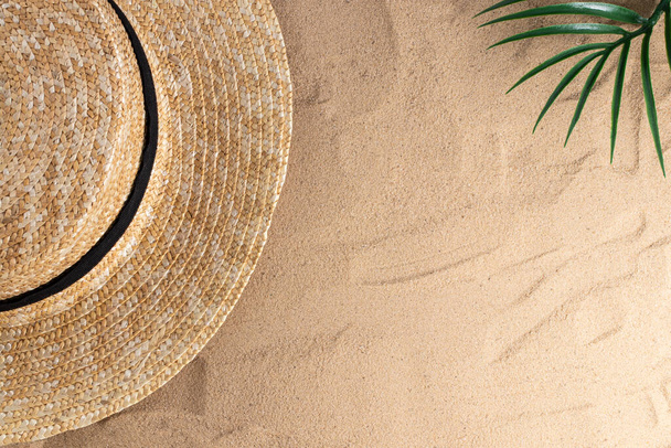 Summer vacation composition. Hat on sand background with a copy of space. Summer background. - Foto, immagini
