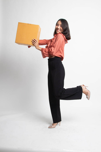 Delivery, relocation and unpacking.  young asian woman holding cardboard box on white background - Фото, зображення