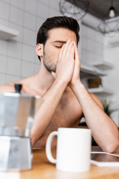 shirtless sad man sitting on kitchen with coffee pot and cup - Φωτογραφία, εικόνα