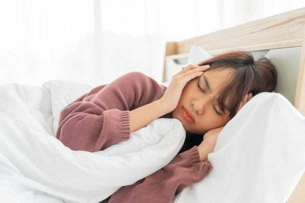 beautiful Asian women headache and sleeping on bed - Photo, Image