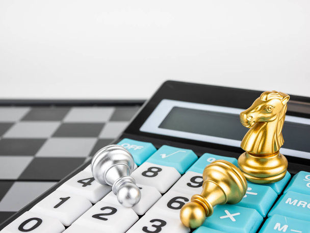 Financial games concept, Game of chess with calculator, selective focus. - Photo, Image