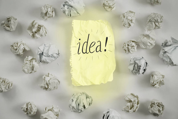 new ideas concept. sheet of paper, paper balls, colorful pencils on white background - Fotó, kép