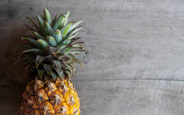 pineapple on old wooden background. top view. over light - Foto, Imagem