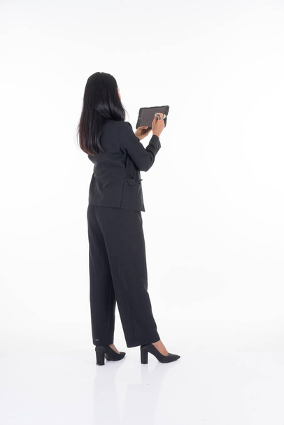 An attractive woman wearing business attire holding a tablet with various poses isolated on white background. Suitable for image cut out and manipulation works for technology,business or finance theme - Foto, Imagem
