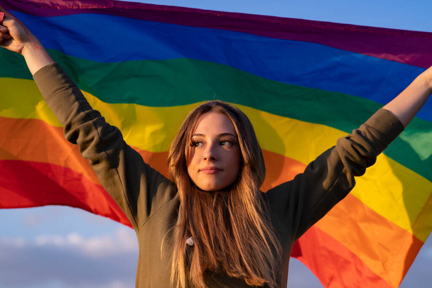 woman raises flag gay pride - Foto, afbeelding