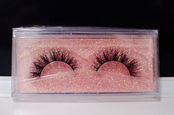 Close-up of beautiful long black new false eyelashes, artificial eyelashes in unopened  plastic box  - Photo, Image