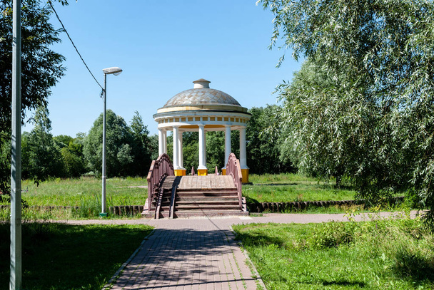 Moscow, Russia, July 13, 2014: Pavilion Air Temple in a city park on the banks of the Yauza River. Wooden bridge to the rotunda. - 写真・画像
