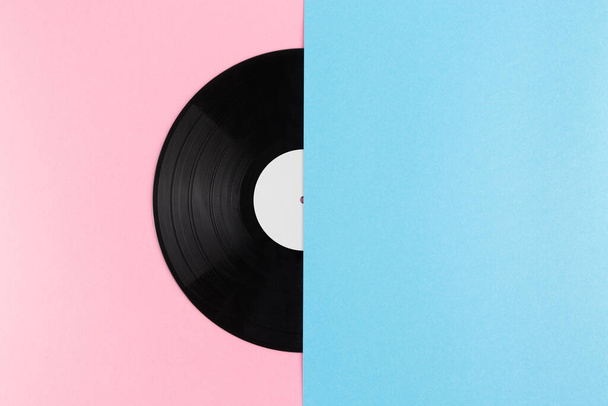 Half of vinyl record on abstract creative pastel pink and blue pastel background with copy space. Creative flat lay concept. - Photo, Image