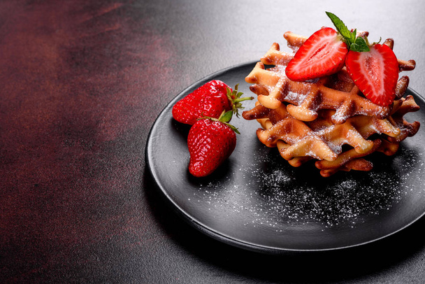 Delicious fresh baked belgian waffles with berries and fruit on a concrete background - Photo, Image