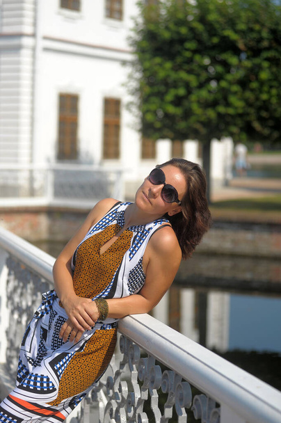 pretty brunette woman in summer wearing sunglasses portrait - Fotó, kép