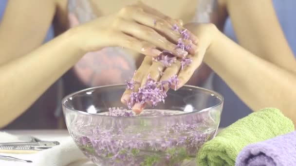 Manicure, nail SPA. Hands of a woman in a bath with flowers. Sensuality, skincare, feminine, salon, wash, wealth, therapy, cosmetics, treatment, relax, dayspa, aromatherapy - Footage, Video