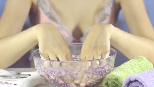 Hands of a woman in a bath with flowers. Manicure, nail SPA. Sensuality, skincare, feminine, salon, wash, wealth, therapy, cosmetics, treatment, relax, dayspa, aromatherapy - Footage, Video