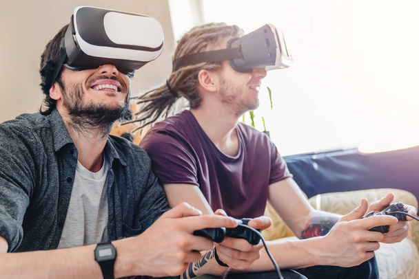 Gaming concept. Cheerful people having fun with new trends technology - Fotoğraf, Görsel