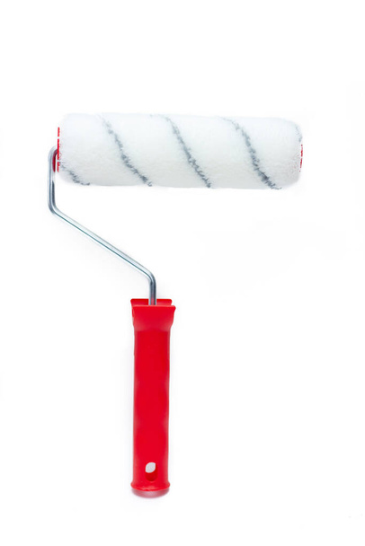 Paint roller on a white background. Tools for repair. Painting the walls. Isolated tools. - Photo, Image