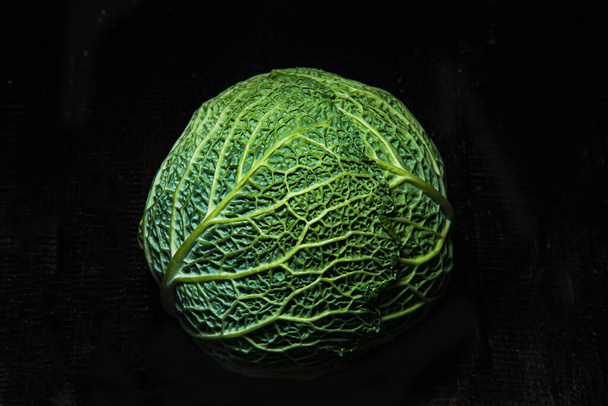 Savoy cabbage on a dark background close-up. Leaf, agriculture. - 写真・画像