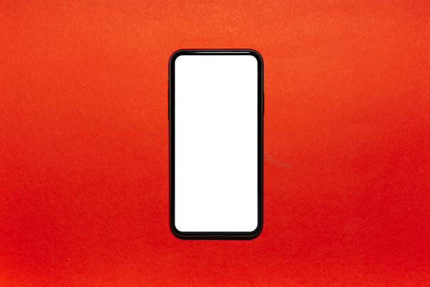 Close-up of modern smartphone with white empty mockup on textured background of lush lava color. - Fotoğraf, Görsel