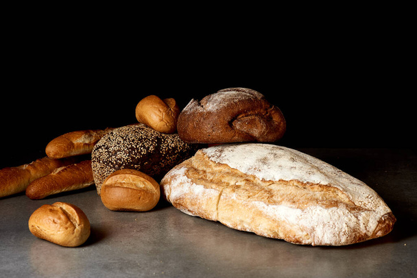 Fresh pastries in assortment on a gray surface. Black background. - Foto, Bild