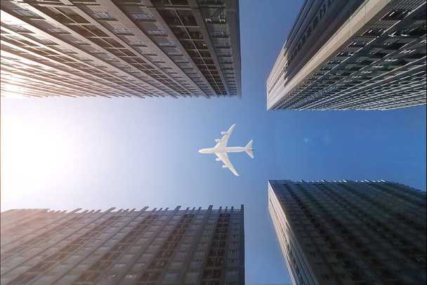Avion survolant des gratte-ciel d'affaires, des immeubles de grande hauteur. transport sur ciel bleu
. - Photo, image