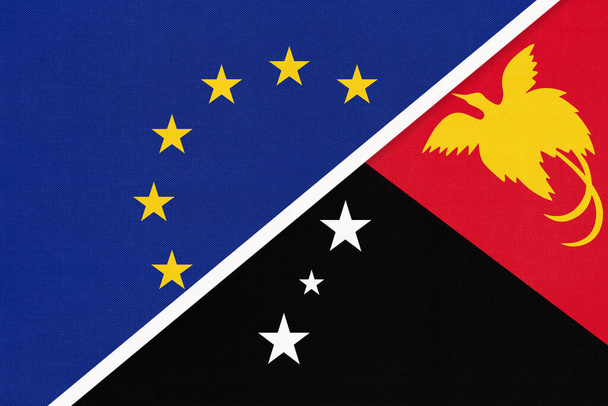 European Union or EU and Papua New Guinea or PNG national flag from textile. Symbol of the Council of Europe association. Europe championship. Oceania country. - Photo, Image