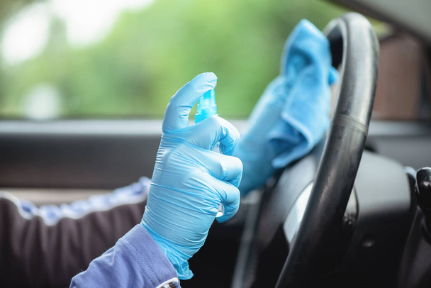 Driver handles car steering wheel with antiseptic close up. - Photo, Image
