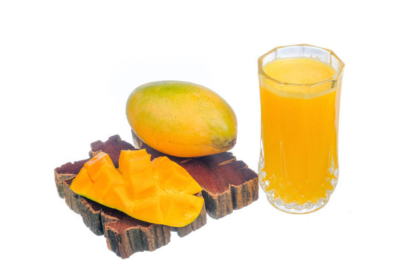 Reife Mango und ein Glas Mangosaft auf weißem Hintergrund - Foto, Bild
