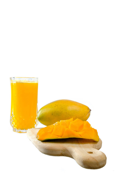 Érett mangó és egy pohár mangó lé fehér alapon - Fotó, kép
