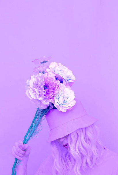 Sensual summer girl with flowers in trendy bucket hat. Purple aesthetic design - Photo, image