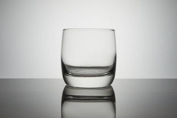 Empty glass for for water, juice or milk on a white background. symbol of thirst. - Fotó, kép