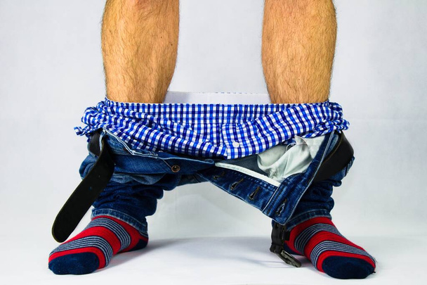 Man has his pants and underwear down  at the ankles. - Φωτογραφία, εικόνα