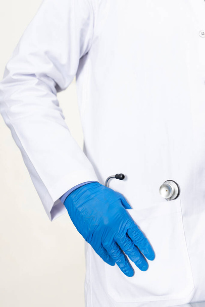 gloves and stethoscope in a white jacket - Φωτογραφία, εικόνα