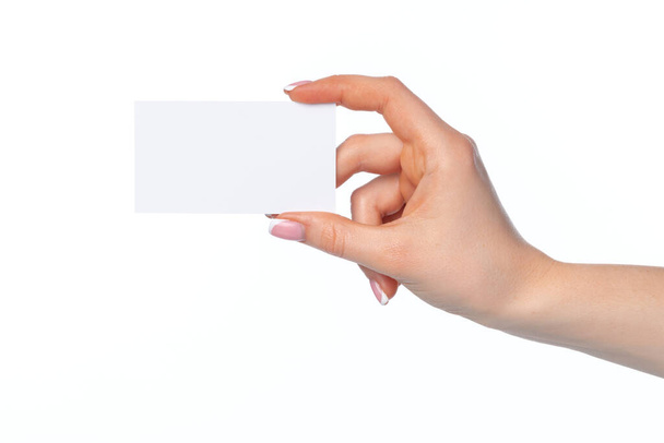 Female hand with blank white business card isolated on white - Zdjęcie, obraz
