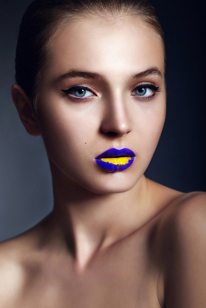 High fashion look.glamor closeup portrait of beautiful sexy stylish young woman model with bright makeup, with creative colorful bright lips with perfect clean skin in studio - Фото, изображение