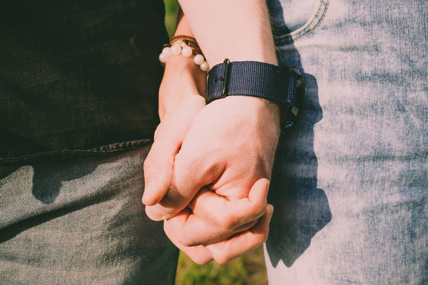 Man and woman hold hands. In the frame only hands close-up. The concept of love, romance, relationship, being together, walking - Фото, зображення