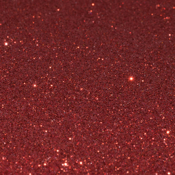 Shiny glitter background in red color. Christmas decoration. - Фото, изображение
