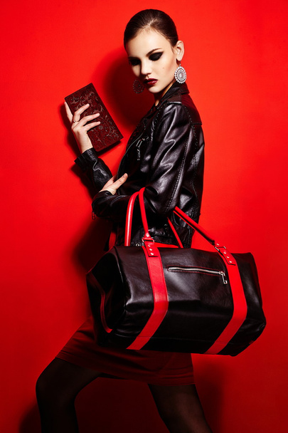 High fashion look.glamor closeup portrait of two beautiful sexy stylish brunette Caucasian young woman model in black jacket with bag bright makeup, with perfect clean skin in studio - Fotoğraf, Görsel