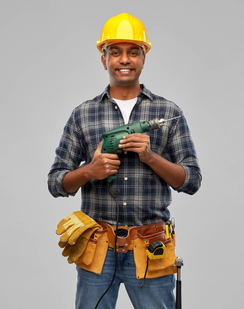 happy indian builder in helmet with electric drill - Foto, Imagem