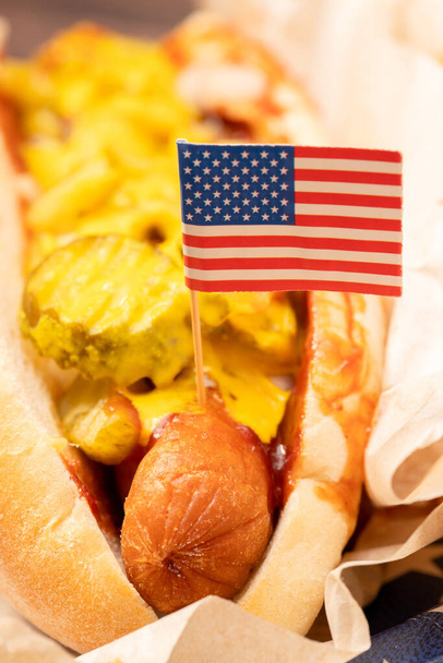 Hot dog juustolla ja suolakurkulla Amerikan lipun kanssa
 - Valokuva, kuva
