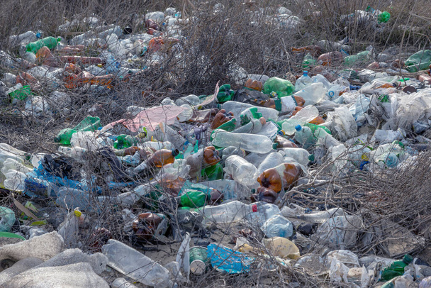 Použité odpadky na mořském pobřeží po sobě zanechávají turisté a rekreanti. Špinavé mořské písčité pobřeží Moře. Znečištění životního prostředí. Environmentální problém má negativní dopad. Prázdné použité špinavé plastové láhve - Fotografie, Obrázek
