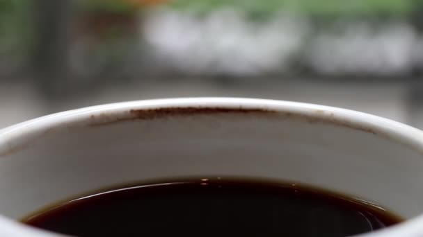 A cup of cooled down black coffee over time with coffee stain. Waiting for someone or relaxing. - Footage, Video