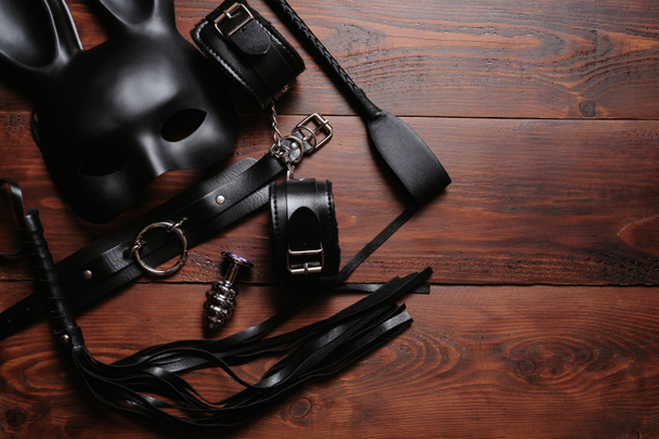 set of sex toys for hard BDSM sex with domination and submission. Leather whip, handcuffs, belt - Fotoğraf, Görsel