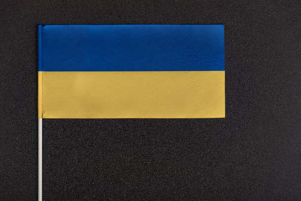 Flag of Ukraine on black background. National symbols of Ukraine. Yellow and blue flag close up. - Foto, imagen