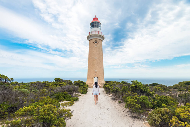 Woman walking towards Cape Du Couedic Lighthouse, Kangaroo Island - Fotó, kép