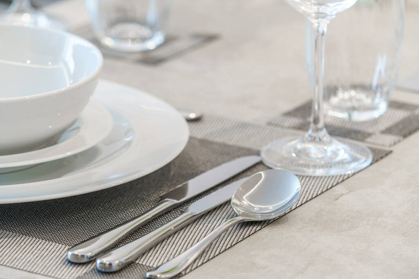Clean white tableware on a table - Фото, зображення