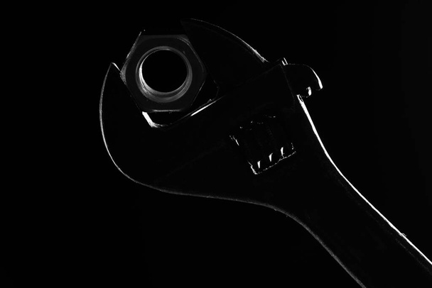 adjustable wrench silhouette on a black background - 写真・画像