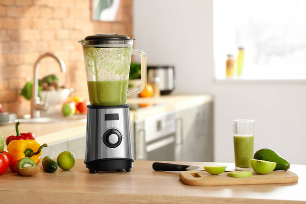 Blender and ingredients for smoothie on kitchen table - Photo, Image